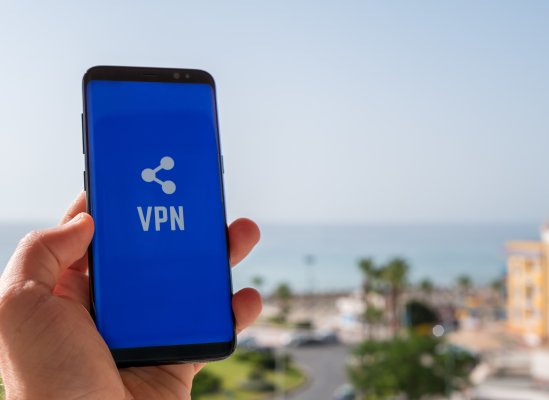 features turbo vpn smartphones mobile devices hand holding smartphone blue screen and vpn exterior beach 